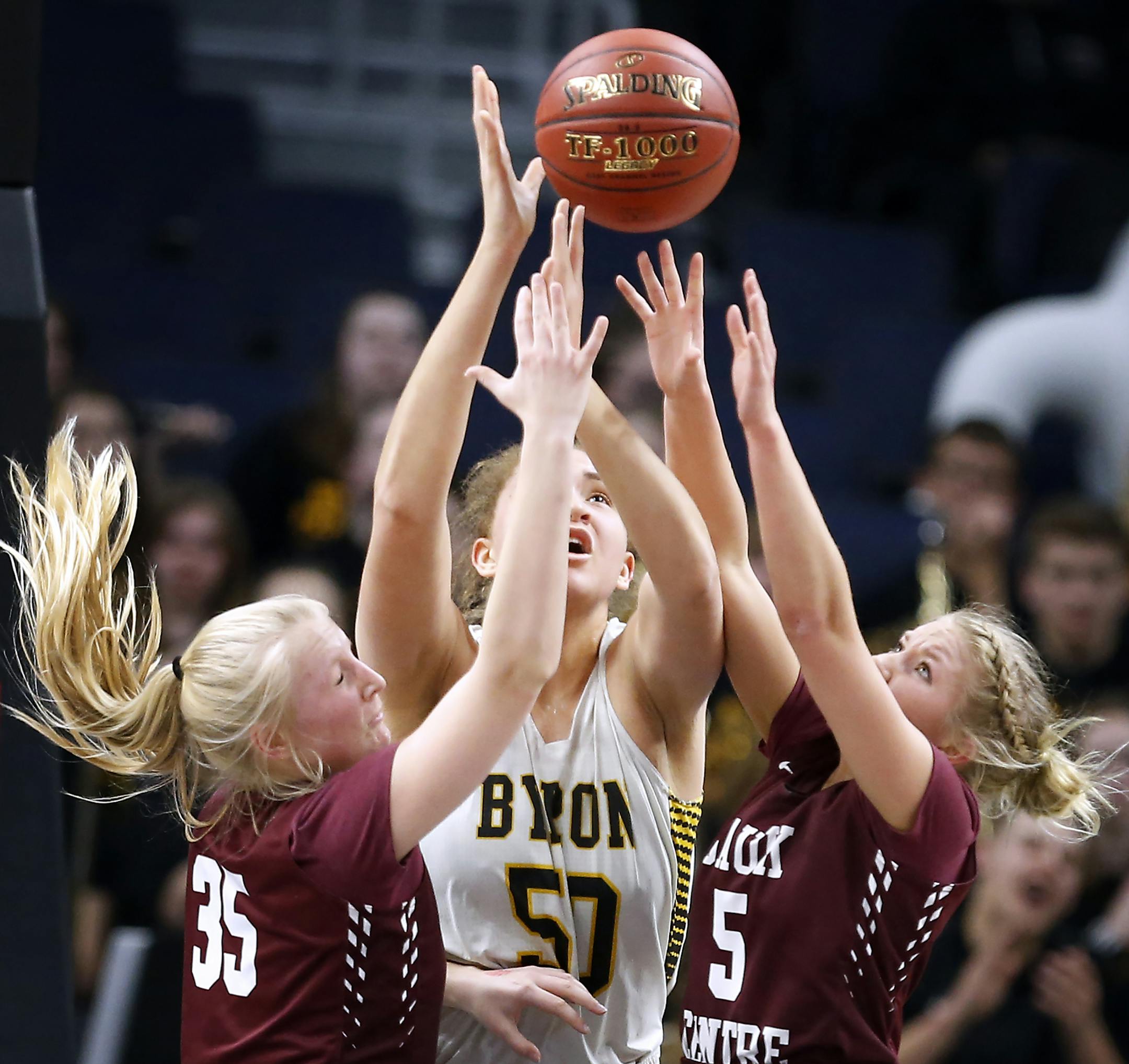 Byron High School center Ayoka Lee (50) fights with Sauk Centre High School center Julia Dammann (35), elft, and Sauk Centre High School guard Kelsey Peschel (5) for a rebound during the first half. ] LEILA NAVIDI ï leila.navidi@startribune.com BACKGROUND INFORMATION: Byron High School plays against Sauk Centre High School in the class 2A quarterfinals of the state girls basketball tournament at Target Center in Minneapolis on Wednesday, March 14, 2018.