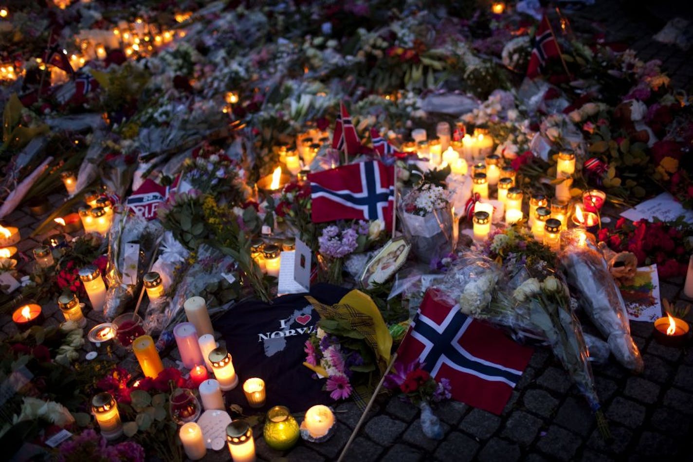 Norwegian flags, flowers and candles paid tribute to victims a day after the July 22, 2011, twin attacks in Norway.