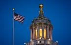 The Minnesota State Capitol was illuminated Thursday evening as the House debated two gun bills that were eventually passed but face a tough path ahea