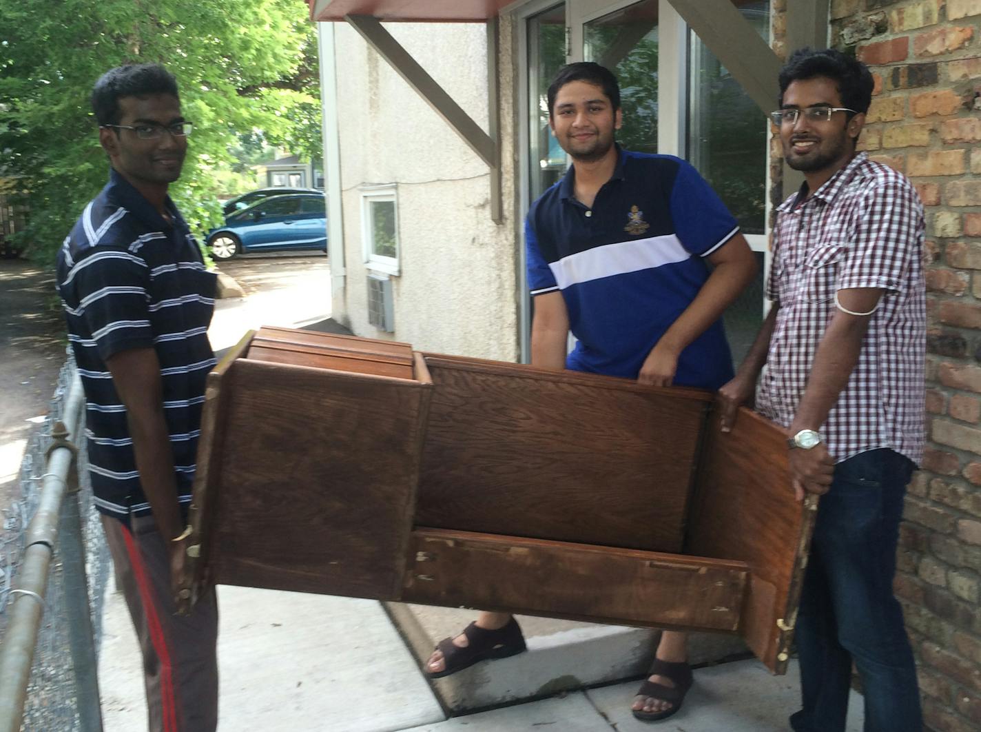 (L-R) Bharathi Prabhu, Abhinav Vsambusivan and Rohit Siedhar helped furnish their new apartment with furniture left on the curb. Photo by Kevyn Burger