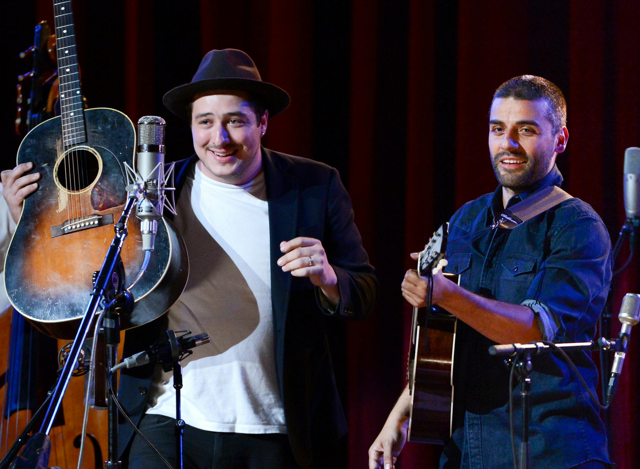 Musicians Marcus Mumford, left, and Oscar Isaac perform together during "Another Day, Another Time: Celebrating the Music of Inside Llewyn Davis" at The Town Hall on Sunday, Sept. 29, 2013 in New York. (Photo by Evan Agostini/Invision/AP)