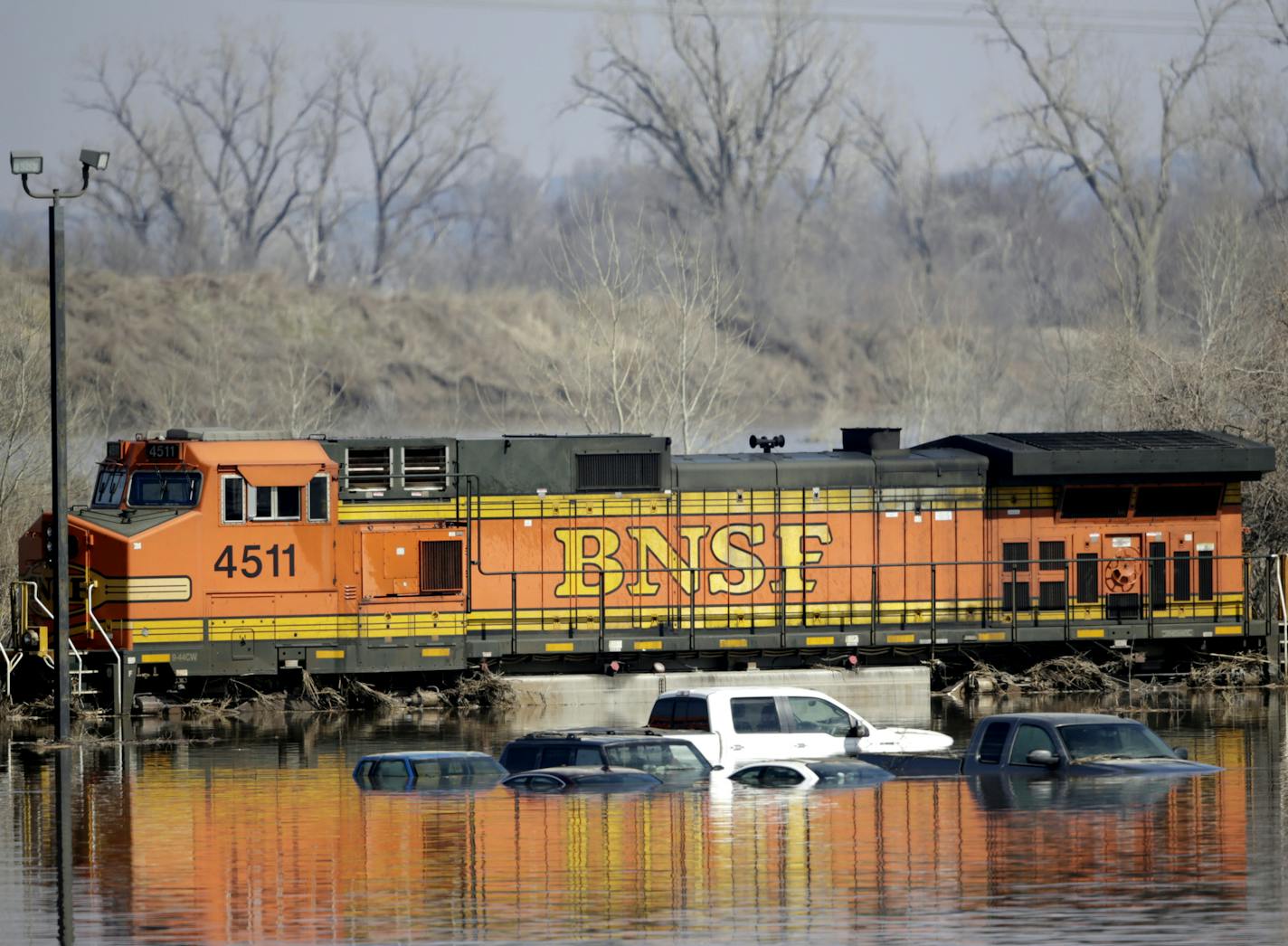 Cars sat Sunday in floodwaters from the Platte River alongside a BNSF train in Plattsmouth, Neb. Hundreds of Nebraskans remained out of their homes.