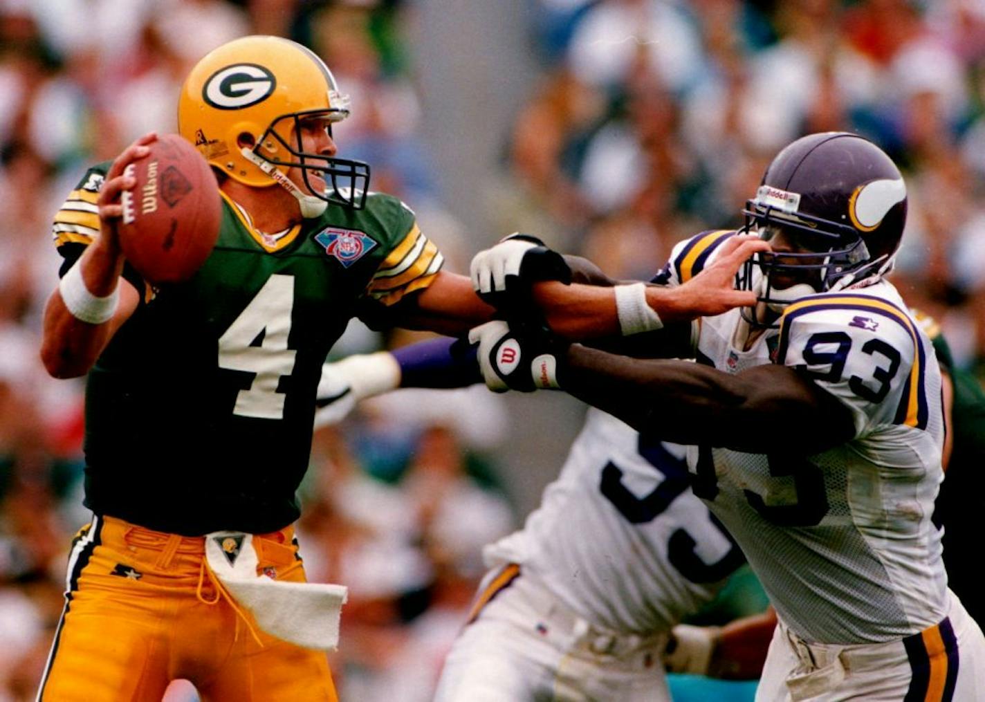 September 5, 1994 Packers quarterback Brett Favre got a handful of John Randle's facemask as he held the Vikings defender at bay to avoid a sack before throwing an incomplete pass. Jerry Holt, Minneapolis Star Tribune ORG XMIT: MIN2015071719211879 Photo taken September 4, 1994