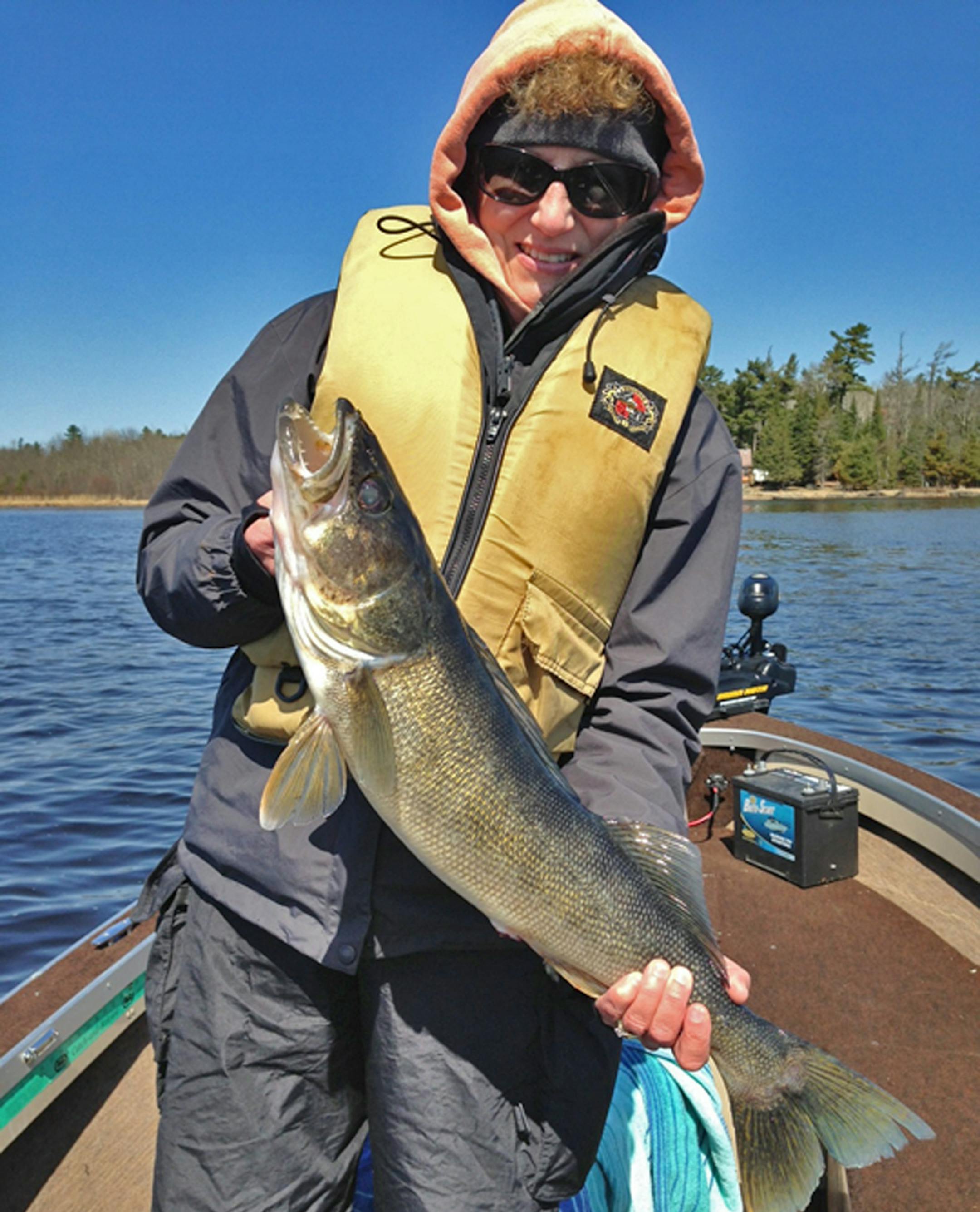 Jodi Weyrauch of Stillwater, Minn., with a 27-inch walleye caught while fishing Crane Lake on the Minnesota opener Saturday. The fish was released. Walleyes under 17 inches can be kept on Crane. One walleye over 28 inches also is allowed.