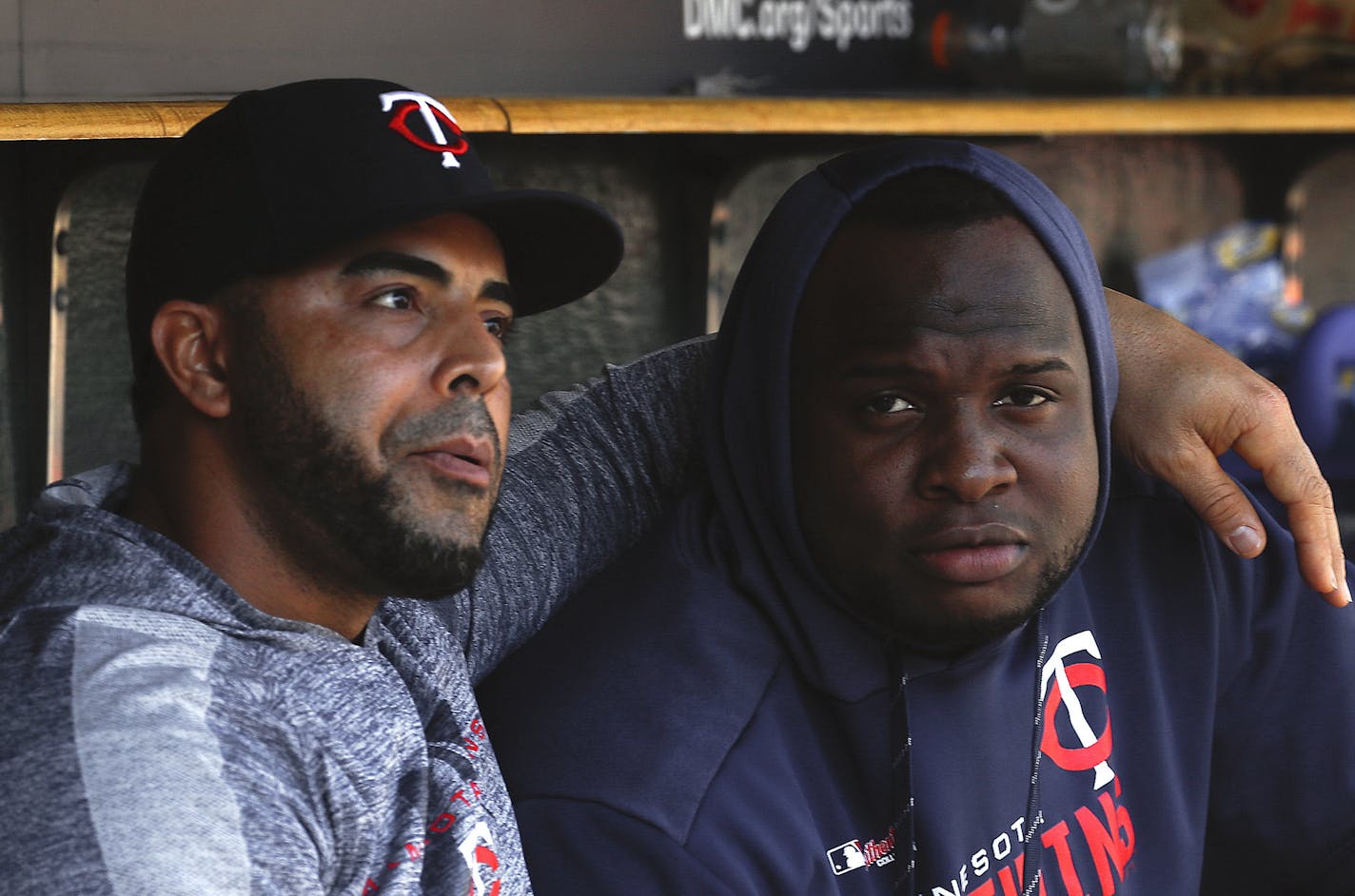 Minnesota Twins' Nelson Cruz, left, and Miguel Sano talk in the dugout in the fourth inning of a baseball game against the Detroit Tigers in Detroit, Thursday, Sept. 26, 2019. (AP Photo/Paul Sancya)