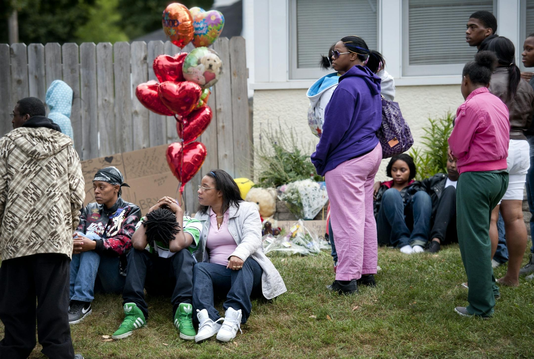 Friends and relatives of Juwon Osborne gathered near the spot in north Minneapolis where the 16-year-old was shot and killed Monday night. He was staying with his mother, Jamica Holden, left, while recuperating from being shot in the leg last week. "I have nothing," Holden said.