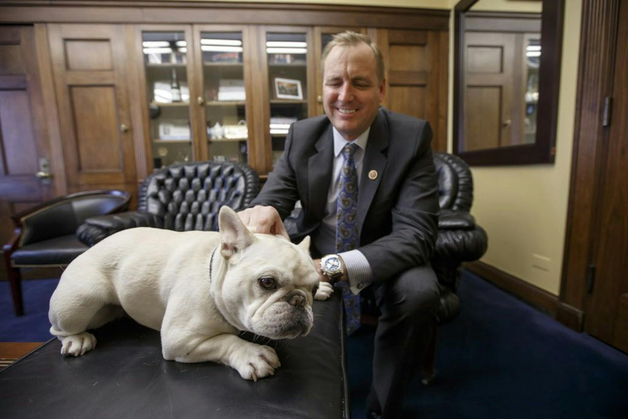 Rep. Jeff Denham, R-Calif. poses with Lily, his 15-pound French bulldog in his office on Capitol Hill in Washington.