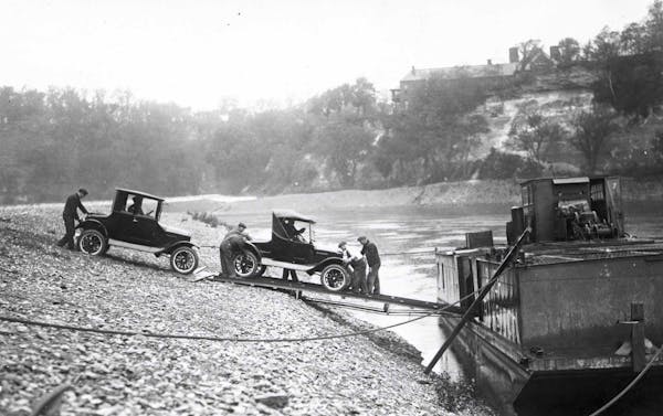 Loading Ford cars from the Ford plant onto river barges for shipment down river. CIRCA 1925 (Location: HE3.7 r4, Negative: 8371) Credit Line: Minnesot