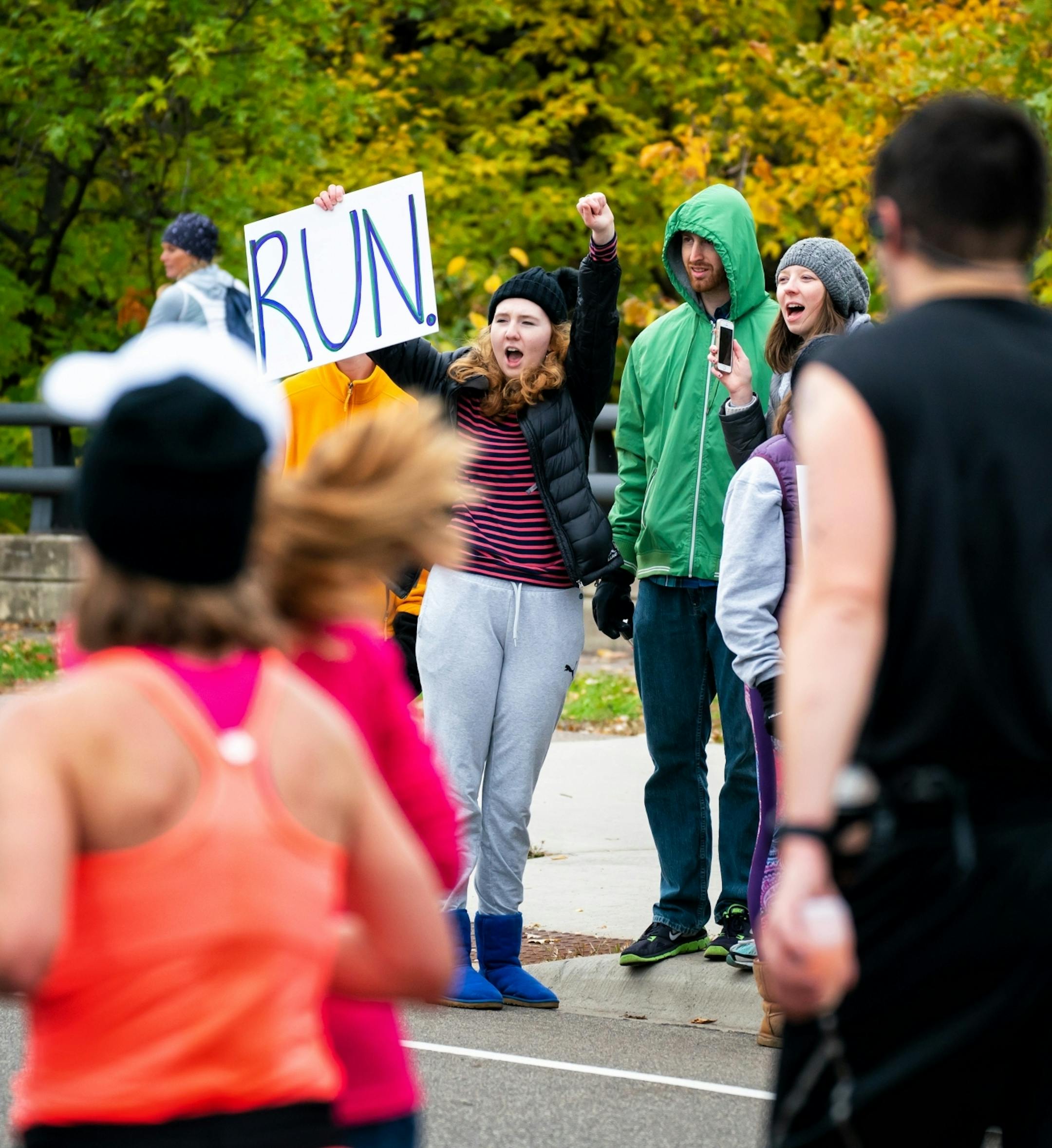 Clare Foreman cheered runners along Mississippi River Blvd near mile marker 21 during the Twin Cities Marathon.
