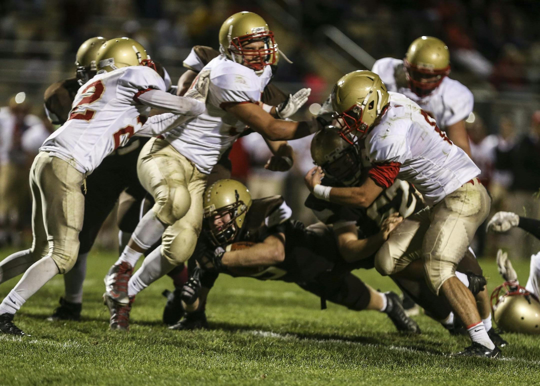 Apple Valley's Kieran McKeag carried the ball as he tried to dive through Henry Sibley defensemen in the first half in Apple Valley, Minn., on Wednesday, October 14, 2015. ] RENEE JONES SCHNEIDER • reneejones@startribune.com Playoff game between Henry Sibley and Apple Valley at Apple Valley High School