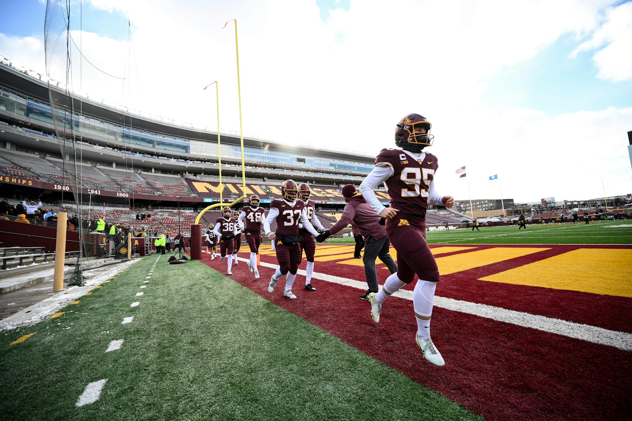 Special teams players, including place kicker Matthew Trickett (95), take the field to warm up.