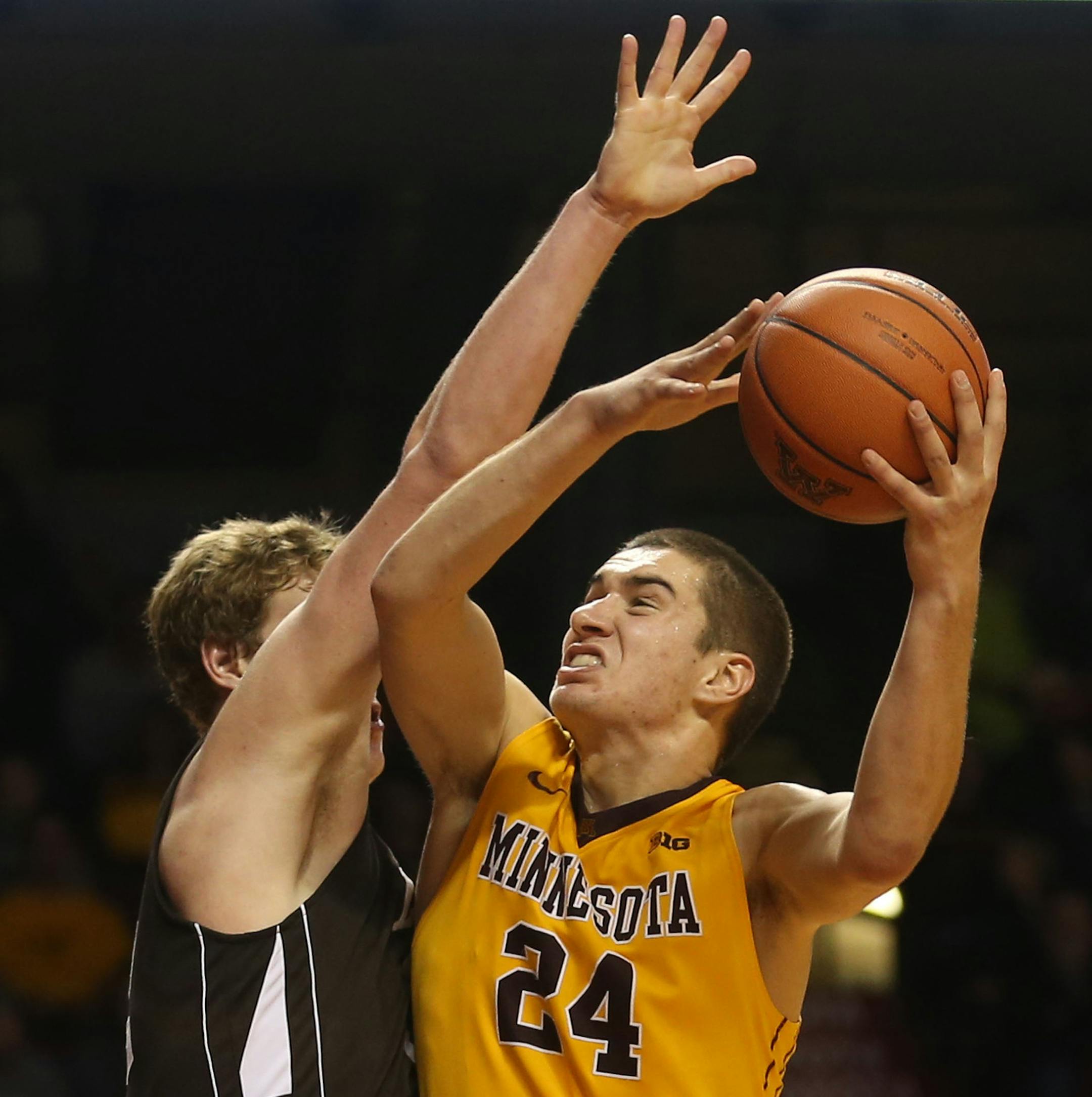 Gopher Joey King went up for a basket with Lehigh's Tim Kempton during the second half at Williams Arena