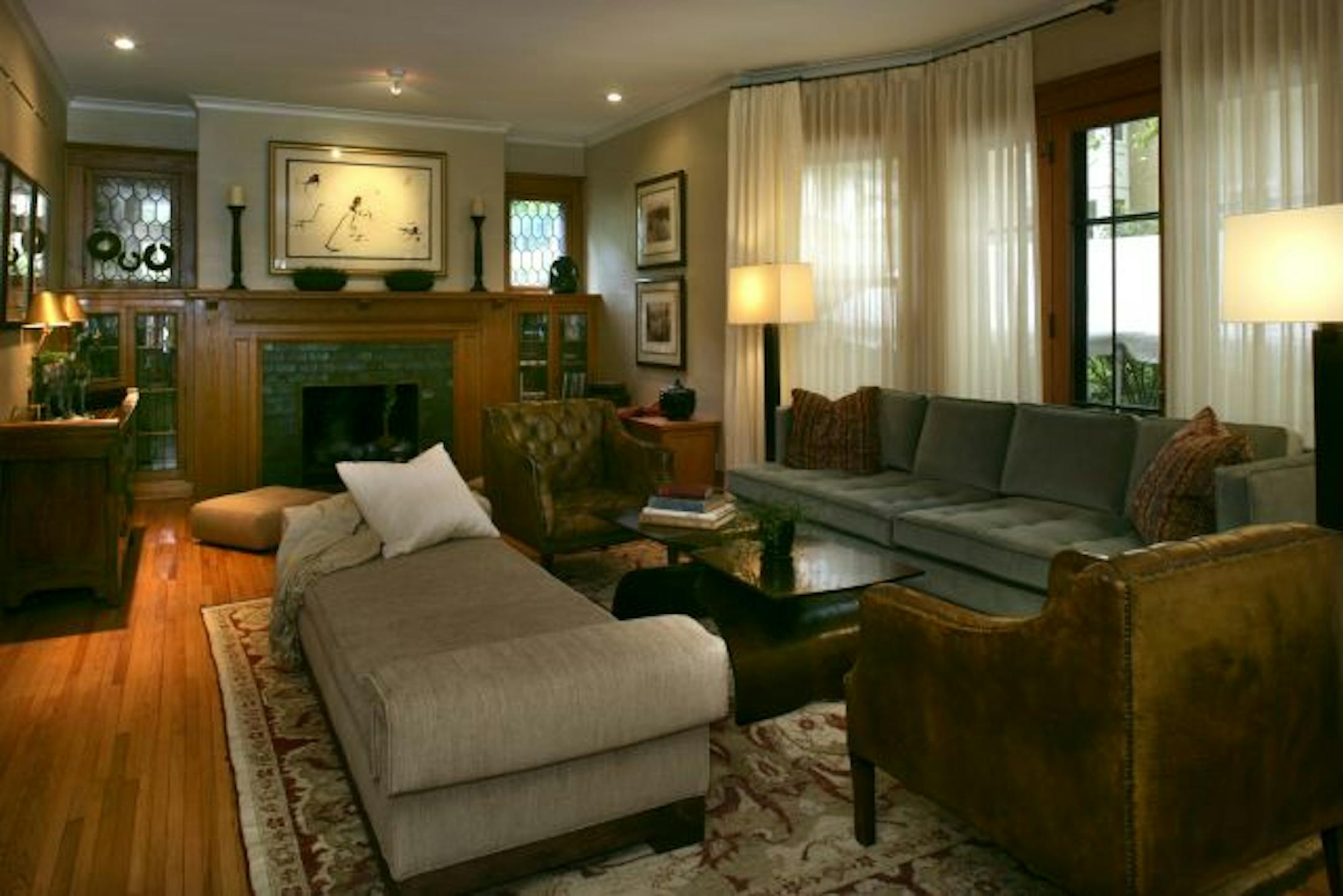 The living room was revamped to accommodate entertaining ("gathering with the tribe"). Designers Carla Bast and Mary Ellen Gardiner incorporated Dan Buettner's artwork, antique Chinese furniture and other artifacts from his travels, mixing them with new artisan-made pieces.