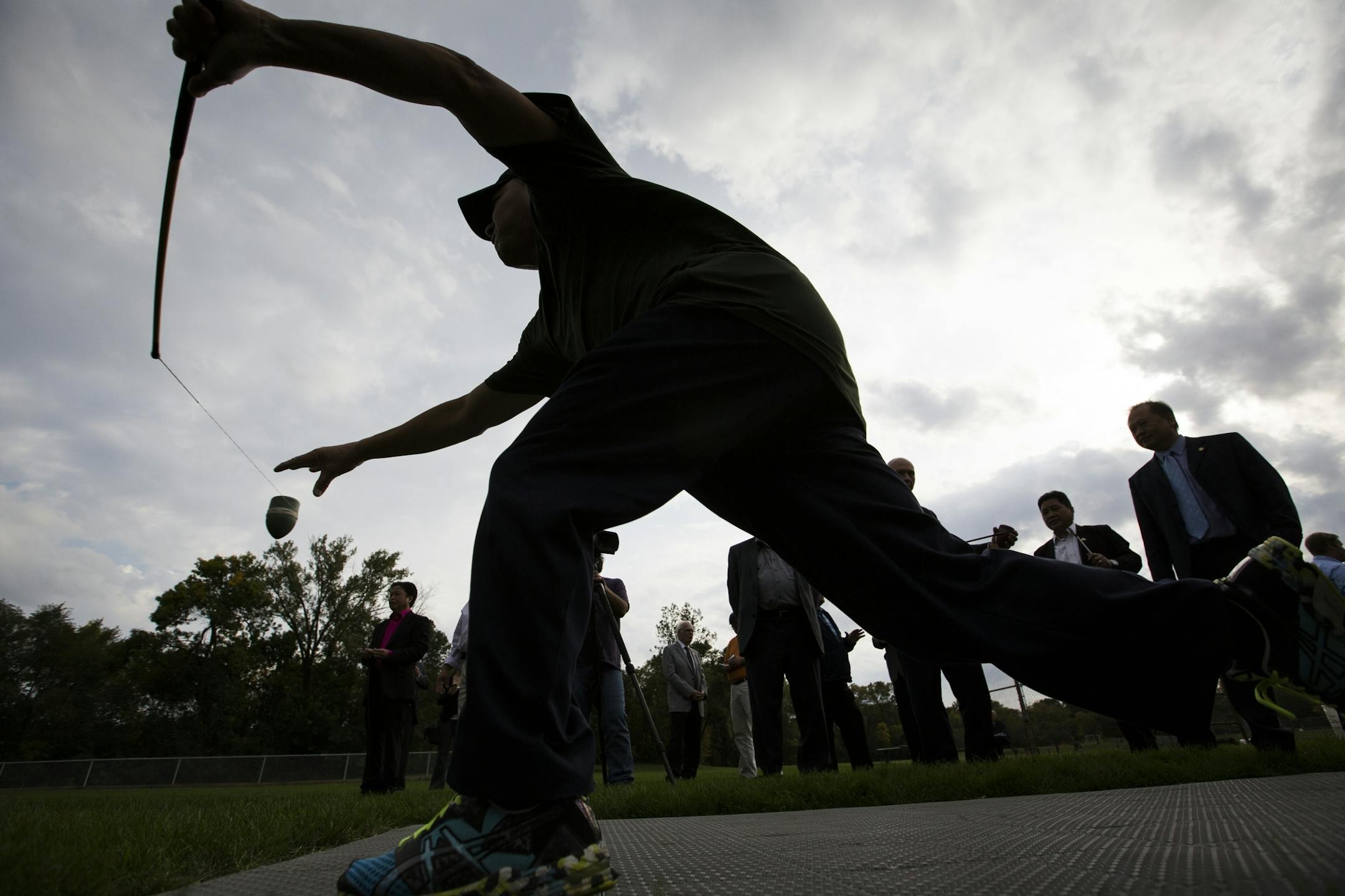 Chang Yang demonstrates the game of Tuj Lub.