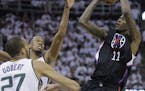 Los Angeles Clippers guard Jamal Crawford (11) shoots as Utah Jazz's Rodney Hood, rear, and Rudy Gobert (27) defend during the first half in Game 4 of