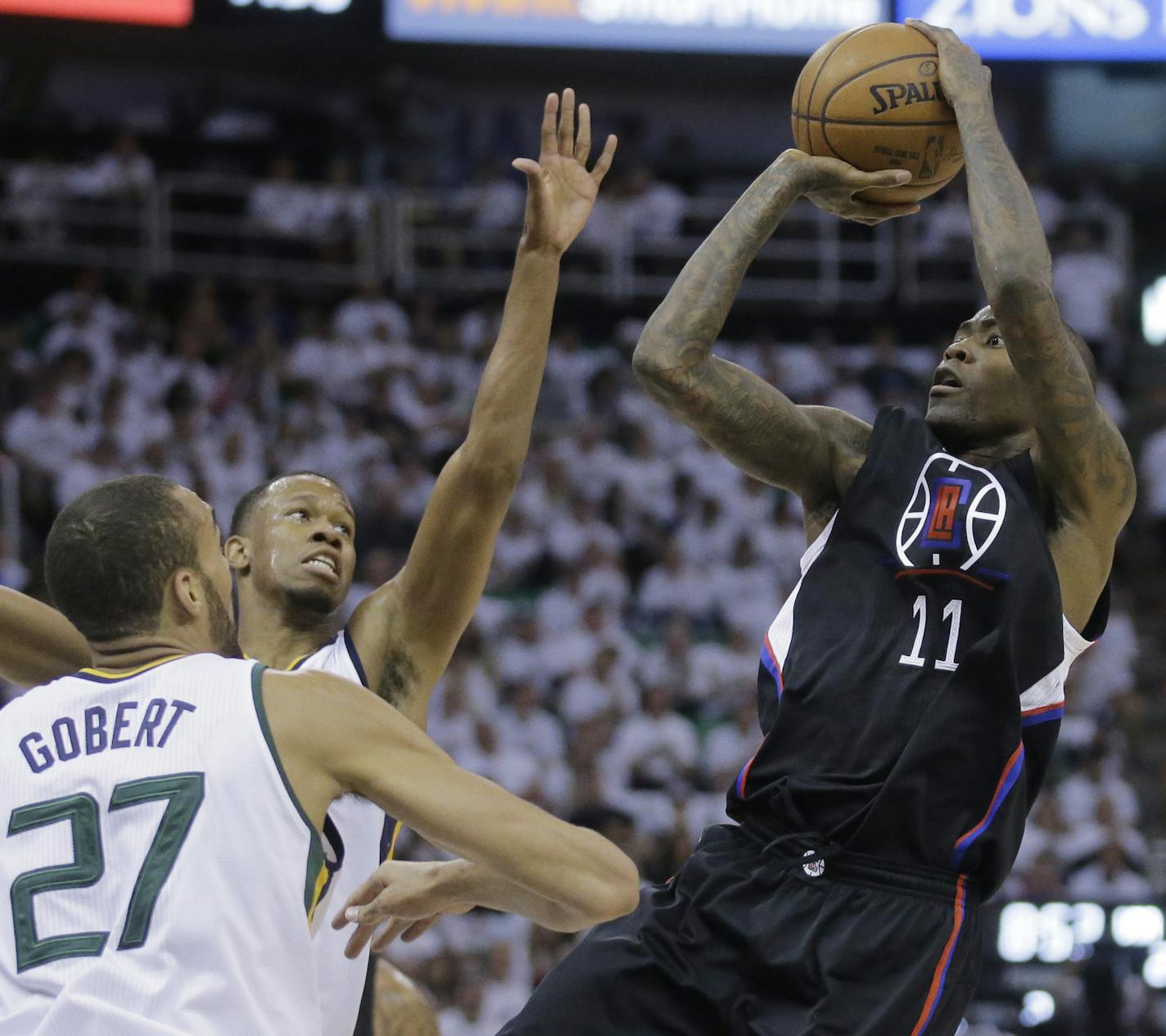 Los Angeles Clippers guard Jamal Crawford (11) shoots as Utah Jazz's Rodney Hood, rear, and Rudy Gobert (27) defend during the first half in Game 4 of an NBA basketball first-round playoff series Sunday, April 23, 2017, in Salt Lake City. (AP Photo/Rick Bowmer) ORG XMIT: UTRB124