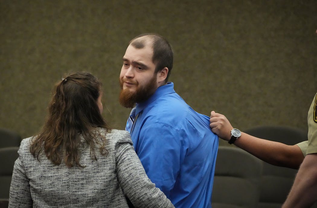 A deputy grabs hold of Cody Fohrenkam's shirt as he's walked out of the courtroom following sentencing.