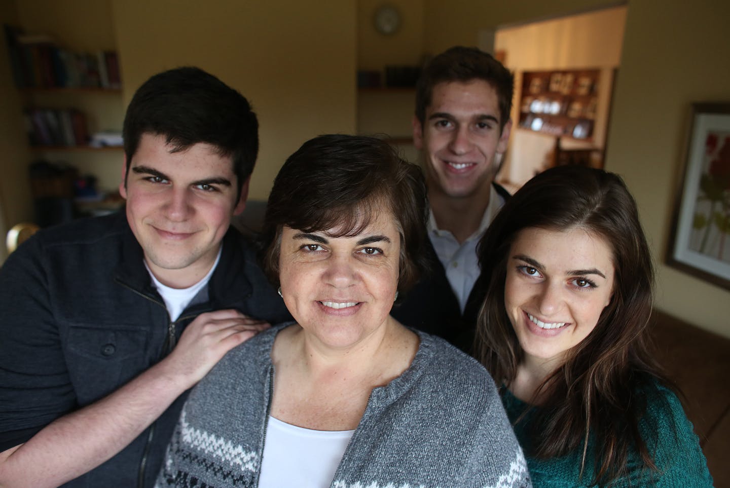 Cheri Frame was surrounded by her children from left Mat, Levi and Kate at home for the holidays. ] (KYNDELL HARKNESS/STAR TRIBUNE) kyndell.harkness@startribune.com At the Frame in Ramsey Min., Wednesday, December 24, 2014. The Frame children learned college credits by taking the College Level Examination Program tests cutting the amount of time and money they had to spend for college.