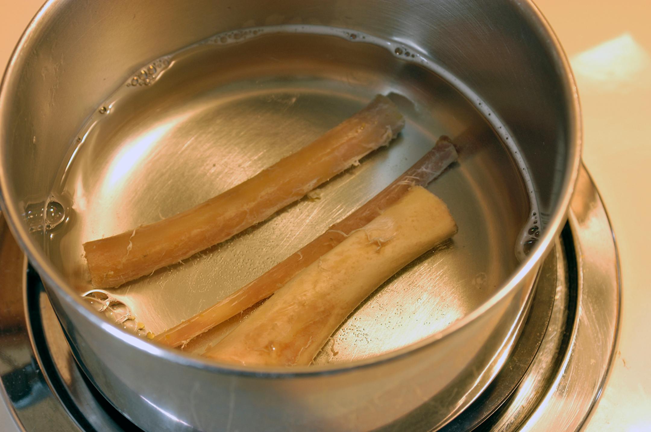 Boil the wing bones in soapy water for about an hour. Then soak them in hydrogen peroxide to further whiten the bones.