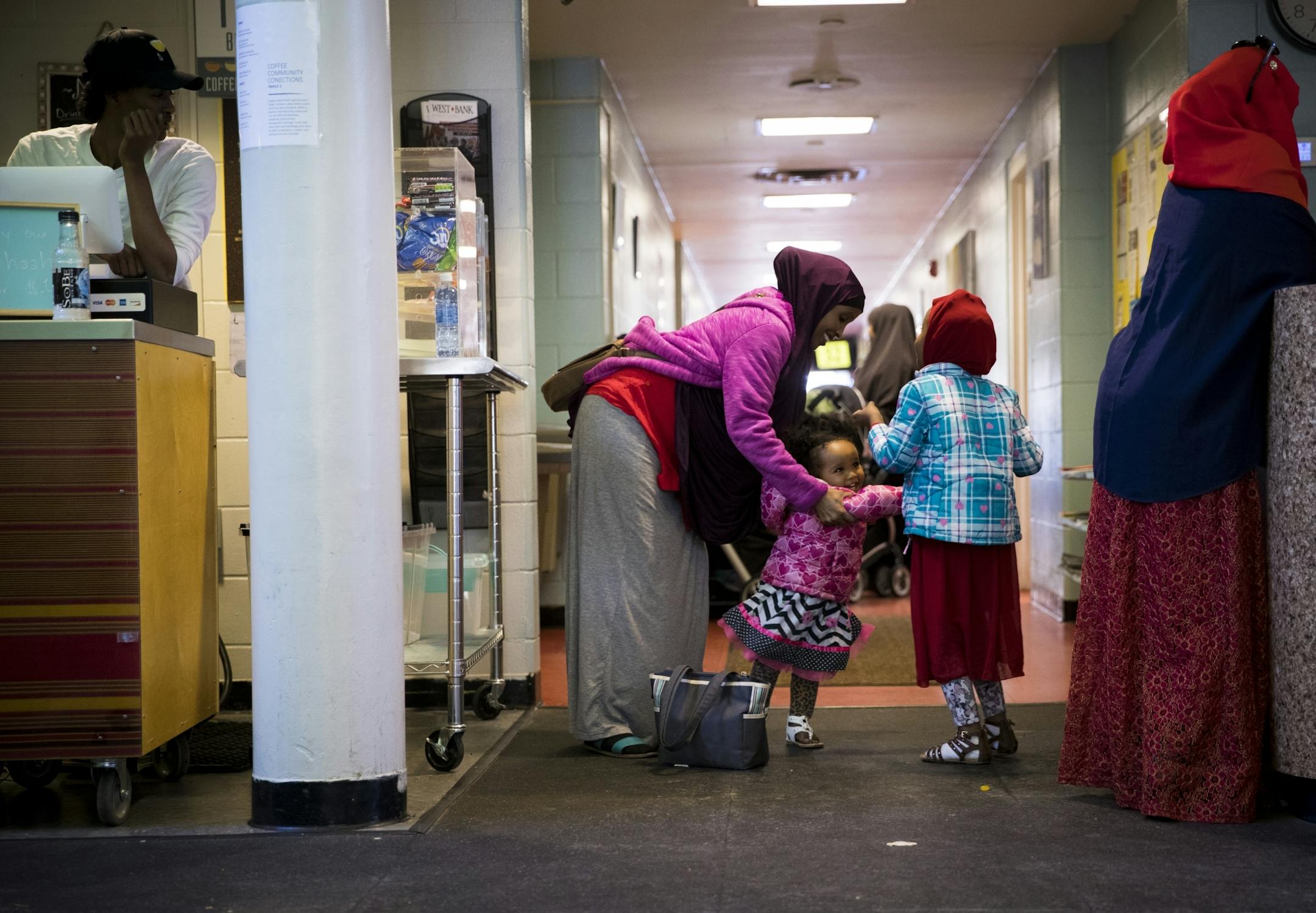 Arfon Ahmed kept her girsl Maid, 1, and Aish, 4, busy as they waited to talk to someone about childcare assistance at the Brian Coyle Center on Monday, October 24, 2016, in Minneapolis, Minn.