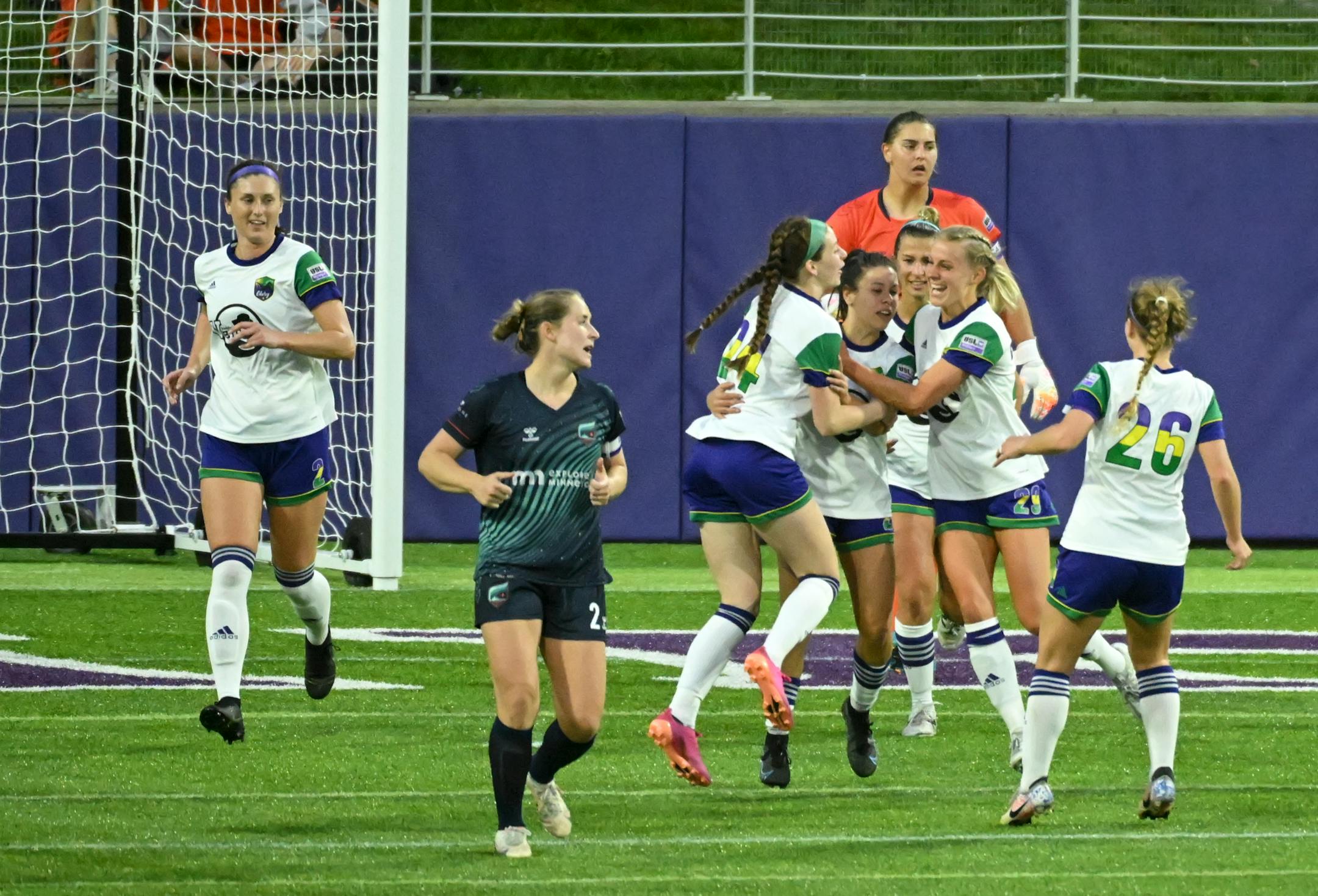 Green Bay players celebrate a late goal against Minnesota during the second half.