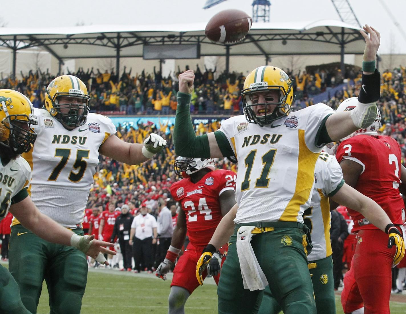 North Dakota State quarterback Carson Wentz (11) celebrates the go-ahead touchdown against the Illinois State with teammates in the second half of the FCS Championship NCAA college football game Saturday, Jan. 10, 2015, in Frisco, Texas.