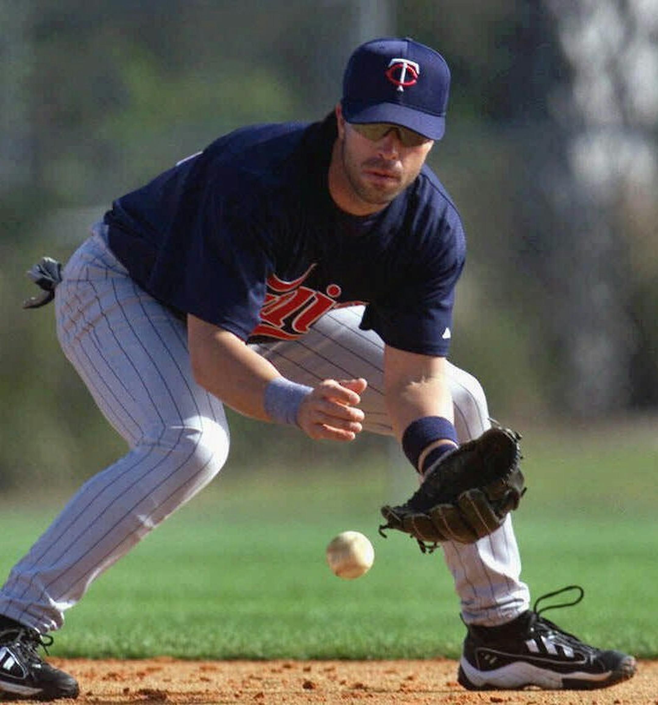 FILE--Minnesota Twins second baseman Todd Walker fields a ball during a spring training practice, in this Feb. 24, 2000 photo, in Fort Meyers, Fla. The Colorado Rockies acquired Walker and outfielder Butch Huskey from the Minnesota Twins on Sunday, July 16, 2000, for infield prospect Todd Sears and cash. (AP Photo/The Star Tribune, Carlos Gonzalez)