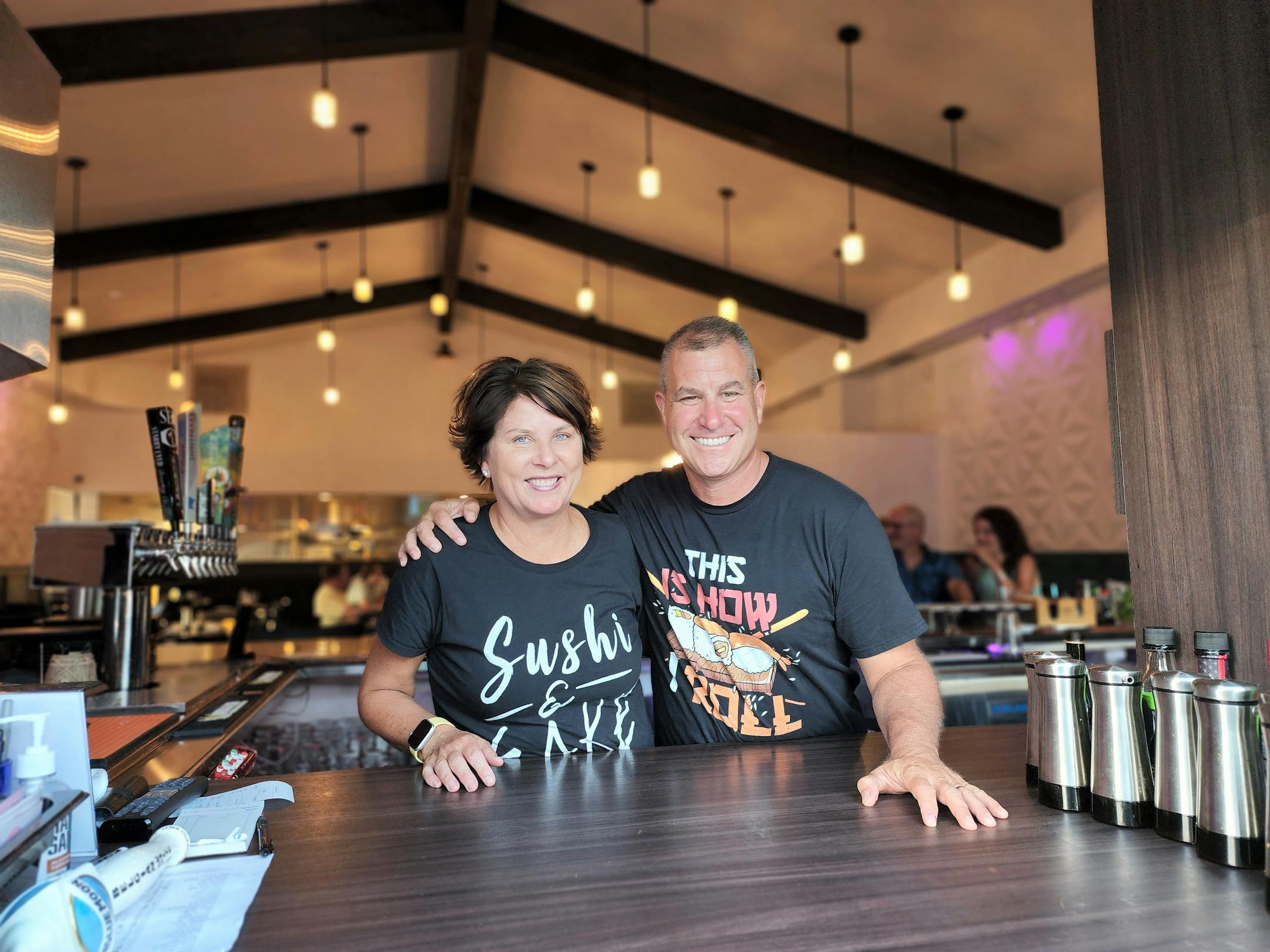 Julie and Lee Bernick stand behind the bar at Kazoku