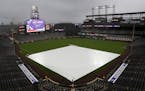 In this file photo from May 8, 2019, rain delays the start of the Colorado Rockies and San Francisco Giants game in Denver.