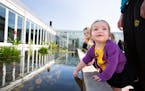 Cailin Anderson, 2, of St. Paul plays in the Centennial Garden at Como Park's Marjorie McNeely Conservatory in St. Paul on Friday, June 19, 2015.