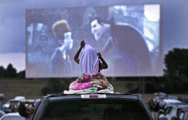 A young movie viewer got comfortable atop the family's vehicle for the double feature of "Ice Age: Continental Drift" and "Brave" at the Cottage View 