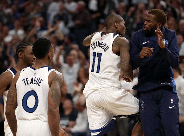Minnesota Timberwolves guard Jamal Crawford (11) celebrated with his teammates after scoring a three point basket in the final minute of the second ha
