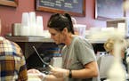 Tracy Hummelgard makes food during the Monday afternoon lunch rush at Mainstreet Coffee and Wine Bar in downtown Lakeville.