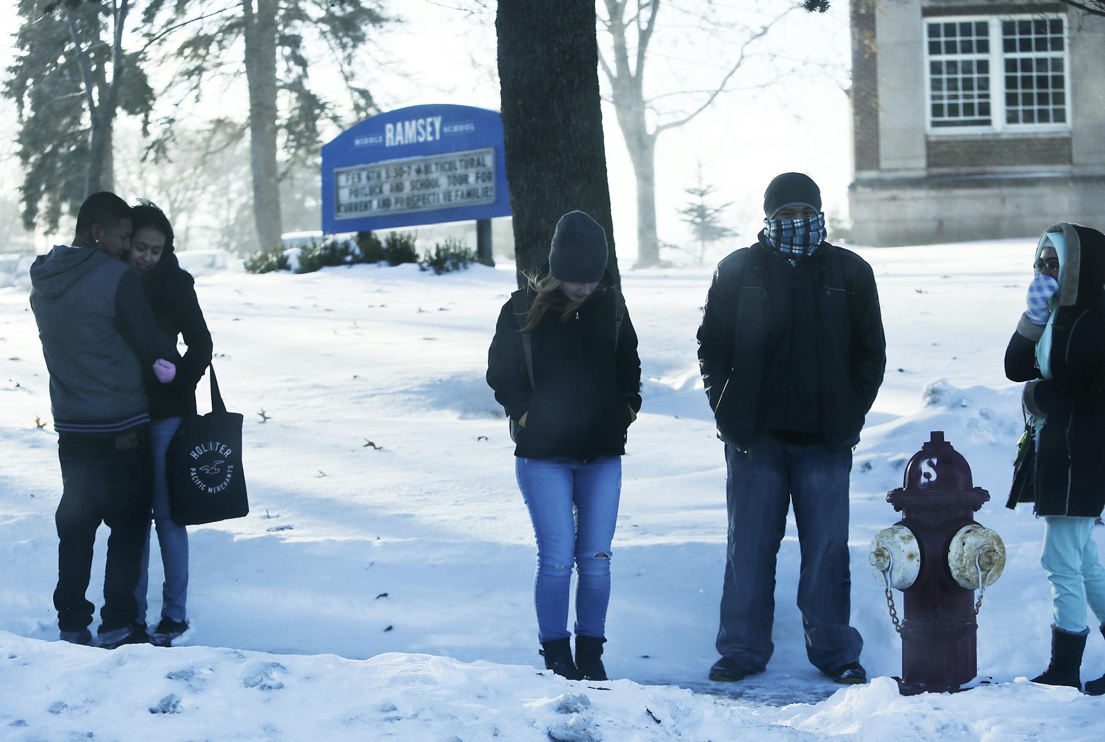Students waiting to catch a bus near Nicollet Ave.S and 50th St. did what they could to stay warm during blizzard-like conditions Wednesday.