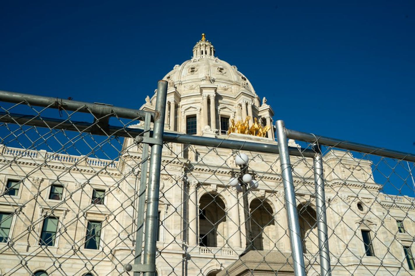 The fence barrier around the State Capitol erected in the aftermath of civil unrest over George Floyd's May killing has remained in place long after state officials predicted it would come down. Now, with a public cost of $274 per day, the fence is poised to stay up well into 2021.