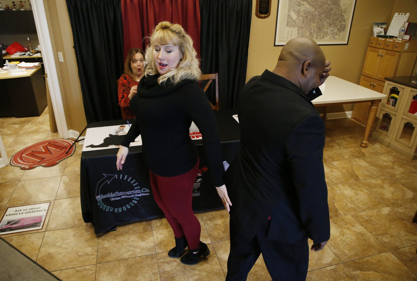 Actor Irene Currie, left, slaps the behind of fellow actor, Ron Anderson, during a rehearsal for a training about harassment in the workplace on Dec. 20, 2019, in Bartlett. The actors work for a company called Taboo Topix which trains employees about workplace harassment, sexual harassment, bullying and discrimination. (Stacey Wescott/Chicago Tribune/TNS)