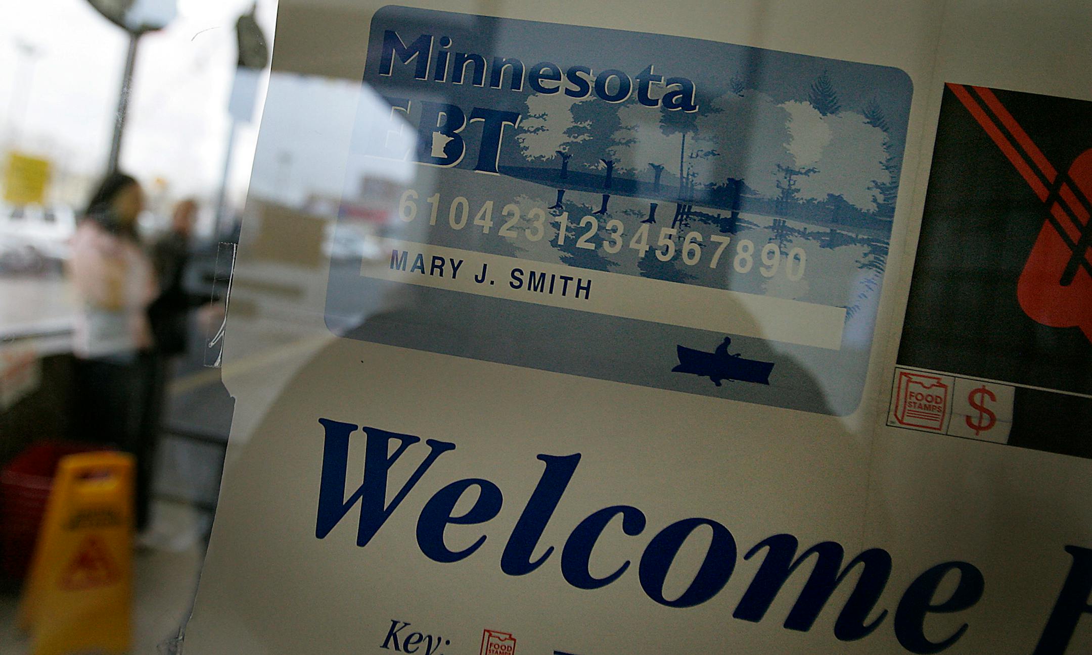 A Minnesota food stamp decal is posted on the door of a grocery store.