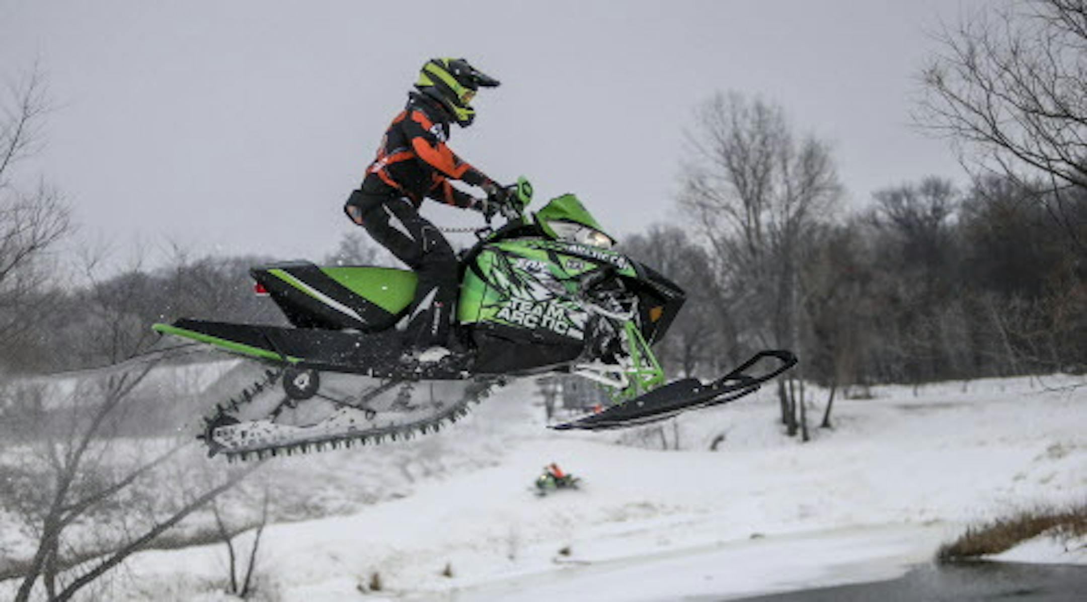 In the cold of winter ERX Motor Park in Elk River is a hotbed for snowcross, a type of snowmobile racing. Even on non-race days, up to 80 competitors plunk down up to $100 to practice on the course. Here, an Arctic Cat rider catches big air Wednesday, Dec. 10, 2014, in Elk River, MN.](DAVID JOLES/STARTRIBUNE)djoles@startribune.com ERX Motor Park in Elk River is a hotbed for snowcross, a type of snowmobile racing. Even on non-race days, up to 80 competitors plunk down up to $100 to practice on th