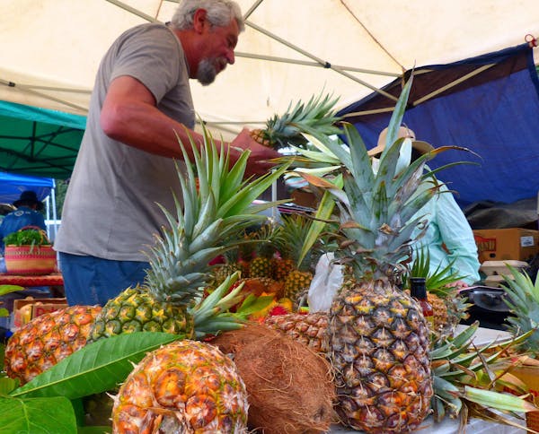 Fresh fruit makes Hanalei's Saturday Farmers Market a visit worth savoring. Besides pineapples and coconuts, a local specialty is longan, a cousin of 