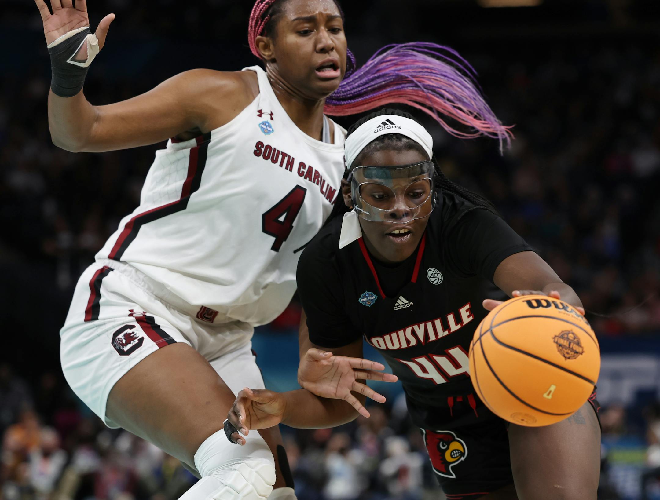 Louisville forward Olivia Cochran, right, drives past South Carolina forward Aliyah Boston.