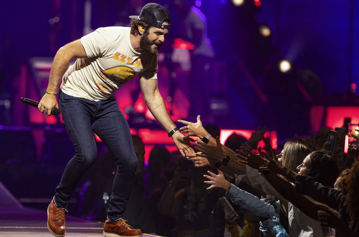 Thomas Rhett slapped hands with fans in the pit during his sold out performance at Xcel Energy Center in St. Paul on Saturday night.]
ALEX KORMANN &#x2022; alex.kormann@startribune.com Country superstar Thomas Rhett performed at the Xcel Energy Center in St. Paul, MN on Saturday September 7, 2019. Opening acts included his father, Rhett Akins, as well as Dustin Lynch and Russell Dickerson.