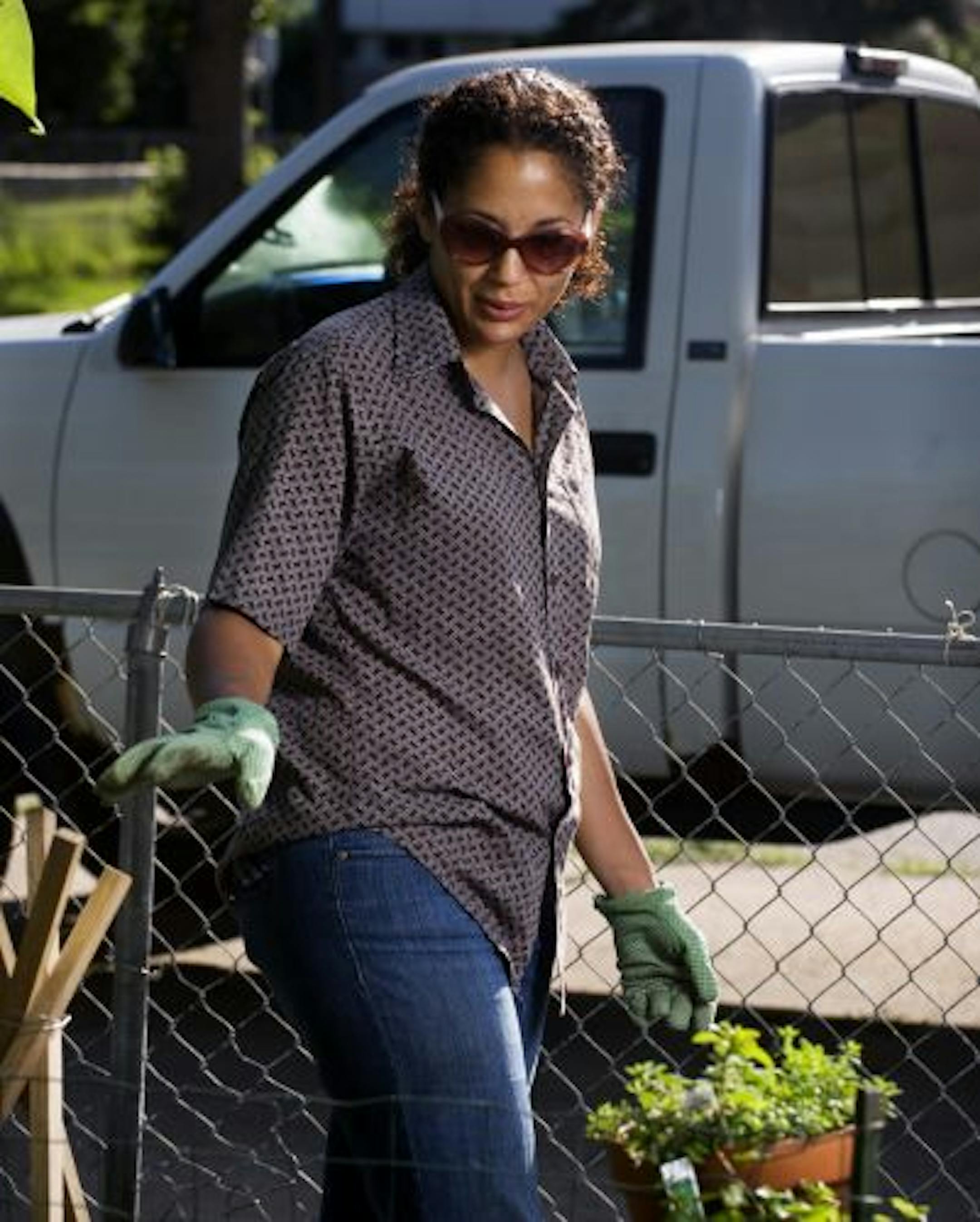 Jamaica DelMar works on her back-yard garden.