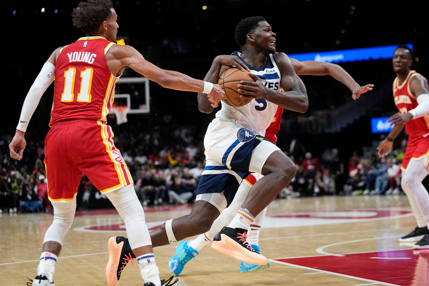 Minnesota Timberwolves guard Anthony Edwards (5) drives past Atlanta Hawks guard Trae Young (11) during the second half of an NBA basketball game, Monday, Oct. 30, 2023, in Atlanta. (AP Photo/John Bazemore)