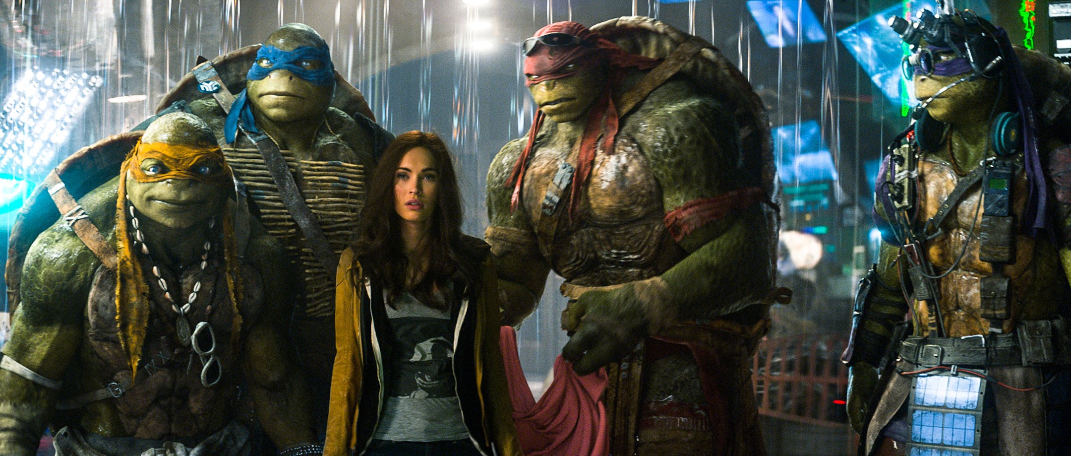 This image released by Paramount Pictures shows, from left, Michelangelo, Leonardo, Megan Fox, as April O'Neil, Raphael, and Donatello in a scene from "Teenage Mutant Ninja Turtles." (AP Photo/Paramount Pictures, Industrial Light & Magic)