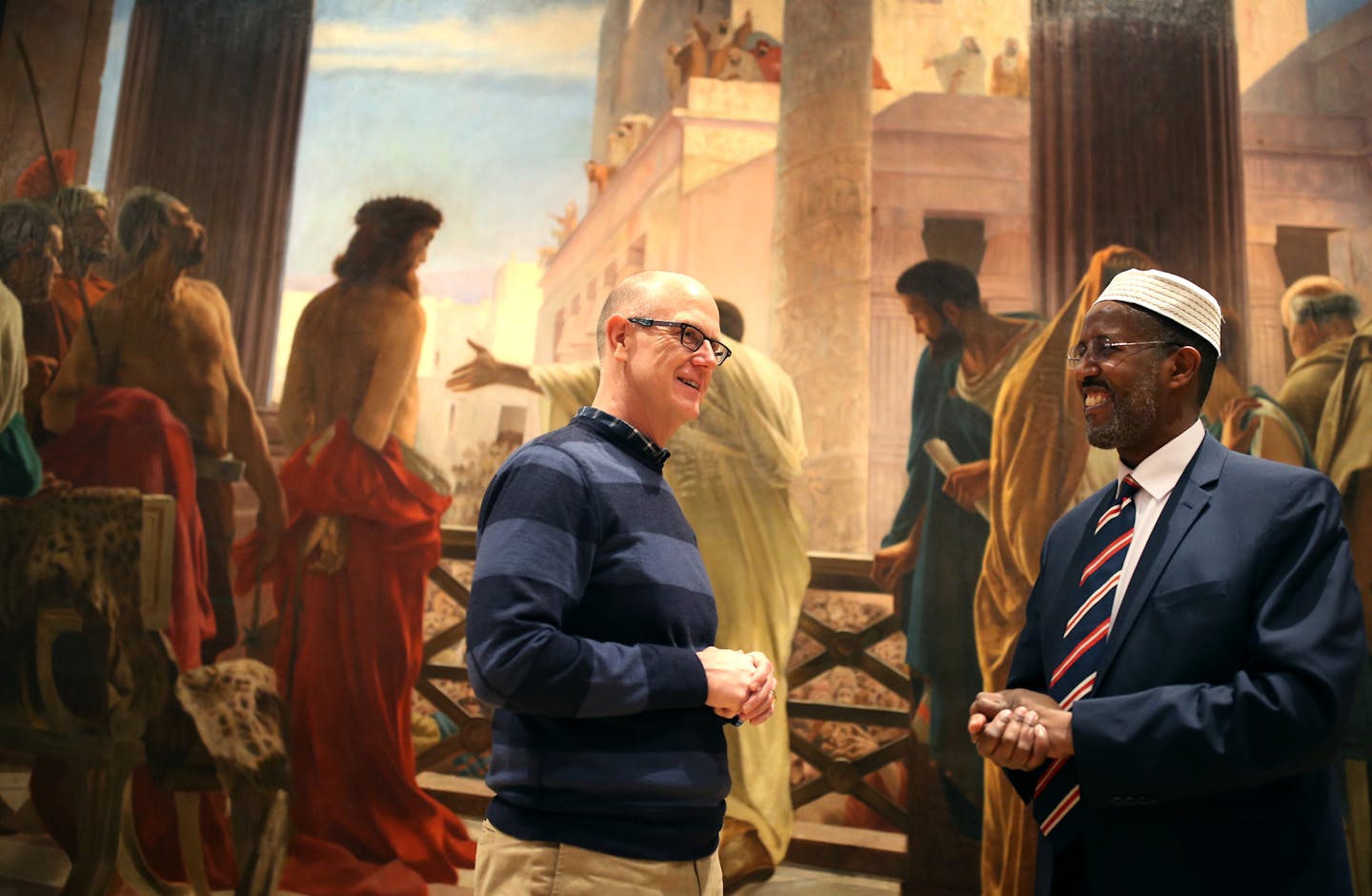 Rev. Jeffrey Sartain, left, and Imam Abdisalam Adam joined other faith leaders in urging President Trump to rescind his immigration order.