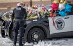 Members of the Eden Prairie Police Department paid their respects on three memorials in front of the Burnsville Police Department in Burnsville on Mon