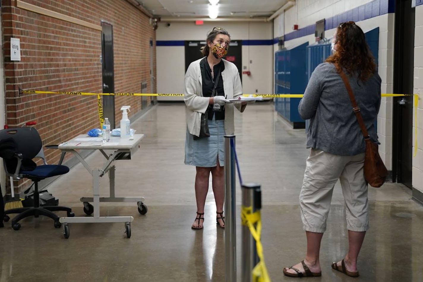 Head election judge Laura Westlund talked with a voter after she'd cast her ballot Tuesday morning at Northeast Middle School in Minneapolis.