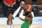 Nigeria's Josh Okogie drives the the basket against Damian Lillard during an exhibition game July 10
