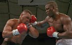 ** ADVANCE FOR WEEKEND EDITIONS, MAY 23-24 ** FILE - In this Feb. 11, 1990 file photo, James "Buster" Douglas, right, hits Mike Tyson with a hard righ