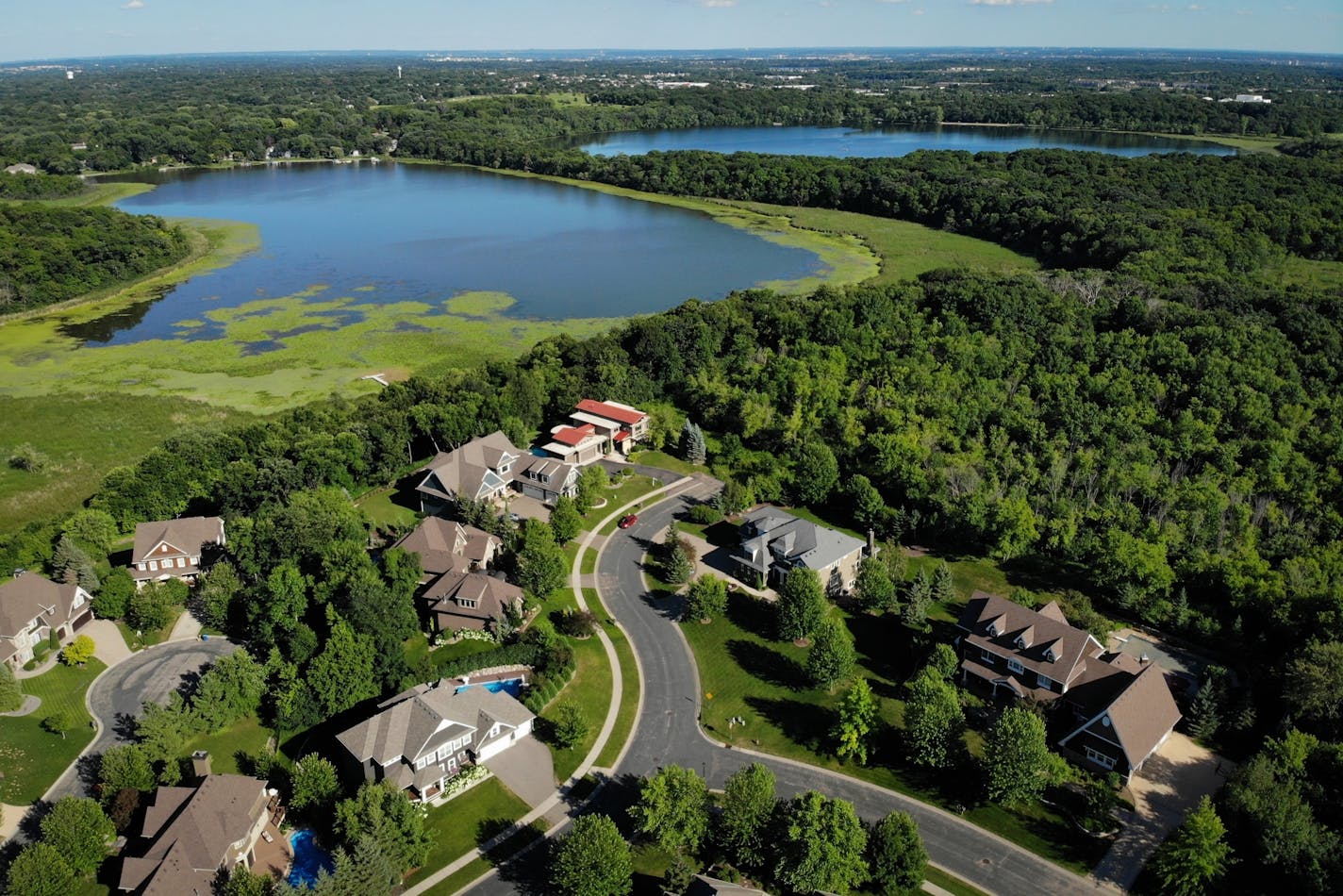 The Lennar Corp. has entered an option agreement to purchase 188 acres of land owned by Prince's estate, as seen from beyond the Lake Lucy Ridge housing community Tuesday afternoon in Chanhassen. Lennar Corp. purchased the vacant land near Lake Ann, top right, and plans to build on the site where the late musician once lived in a yellow three-story mansion.